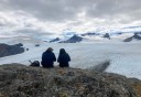 Photo of hikers gazing at Harding Icefield